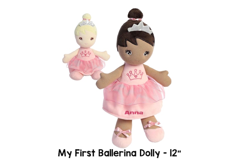 May include: Two 12-inch plush ballerina dolls. One doll has blonde hair and a pink dress with a crown. The other doll has brown hair and a pink dress with a crown and the name "Anna" embroidered on it.