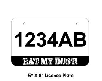 May include: A white license plate with black text that reads "1234AB" and "EAT MY DUST!" in a distressed font. The plate is 5 inches by 8 inches.
