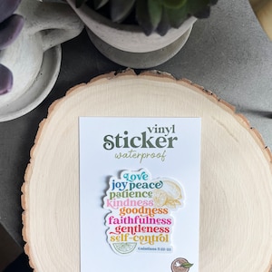 May include: A colorful vinyl sticker with the words "Love, Joy, Peace, Patience, Kindness, Goodness, Faithfulness, Gentleness, Self-Control" and the scripture reference "Galatians 5:22-23". The sticker is waterproof and features a lemon design.