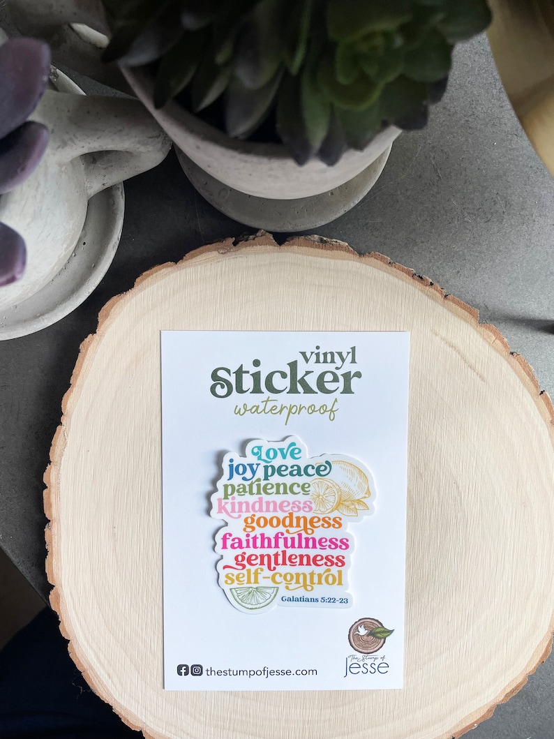 May include: A colorful vinyl sticker with the words "Love, Joy, Peace, Patience, Kindness, Goodness, Faithfulness, Gentleness, Self-Control" and the scripture reference "Galatians 5:22-23". The sticker is waterproof and features a lemon design.