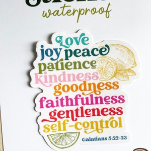 May include: A colorful sticker with the words "Love, Joy, Peace, Patience, Kindness, Goodness, Faithfulness, Gentleness, Self-Control" and the scripture reference "Galatians 5:22-23". The sticker features a lemon design.