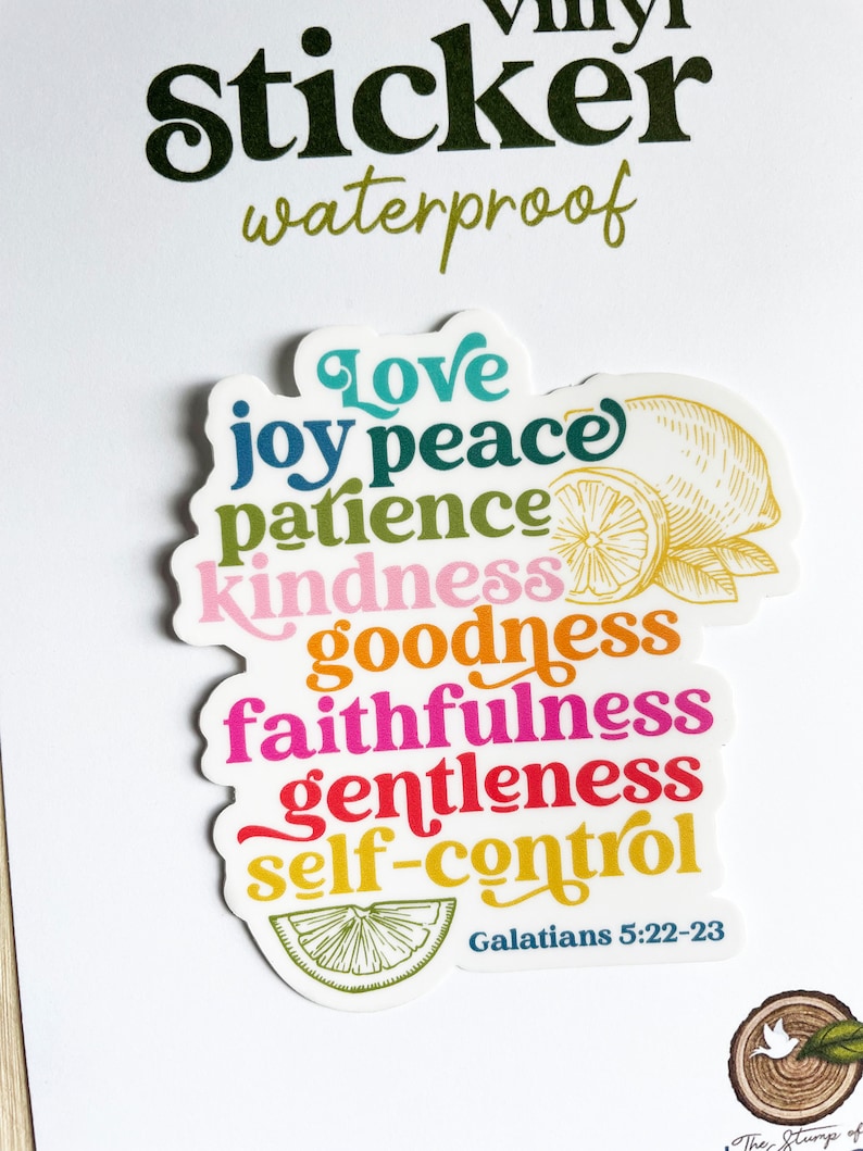 May include: A colorful sticker with the words "Love, Joy, Peace, Patience, Kindness, Goodness, Faithfulness, Gentleness, Self-Control" and the scripture reference "Galatians 5:22-23". The sticker features a lemon design.