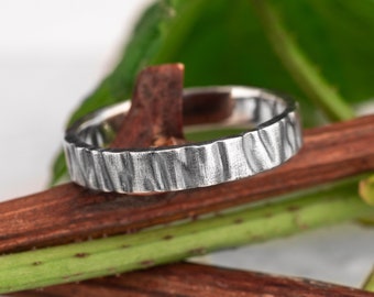 Sterling silver wedding ring with a hammered surface.  Unique ring for men and women.