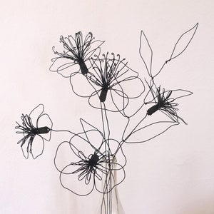 Large bouquet of stylized poppies and wild flowers in black wire, minimalist decoration, floral decoration, bouquet to offer, gift idea.