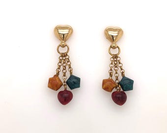 May include: Gold heart-shaped dangle earrings with a chain and three beads in orange, green, and red.