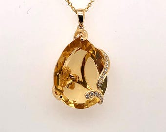citrine pear shaped pendent with diamond accents. 14k yellow gold pendent and chain