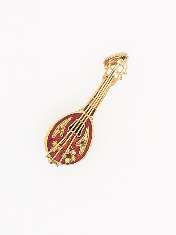 Oud guitar in 18kt gold with enamel.