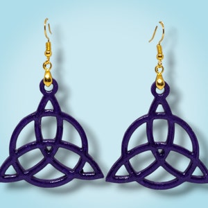 May include: A pair of purple earrings with a gold hook and a Celtic knot design.