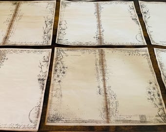 May include: Several sheets of aged paper with floral and script designs. The paper has a vintage aesthetic, with faded colors and distressed edges. The floral elements are detailed, and the script adds to the antique feel.