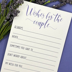 May include: A white card with black lines and purple text that reads 'Wishes for the couple'. The card has prompts for writing wishes for a couple, including 'Always', 'Never', 'Sometimes you have to', 'Don't worry about', and 'My wish for you'. The card also has a small heart with the text 'With love'.