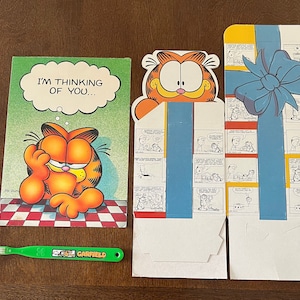 Garfield, o gato, caixa de presente, cartão e escova de dentes.1976.