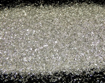 May include: A pile of silver glitter, a sparkly material used for crafts and decorations.