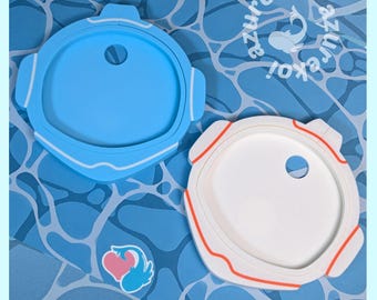 May include: Two circular container lids, one light blue and one white with orange accents, each featuring a small circular hole. The white lid has orange trim along the edges. A small logo with a heart and fish is visible near the lids.