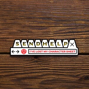 May include: White sticker with black outline and gold lettering that reads "SEND HELP" with a red 20-sided die and arrows pointing left and right. The sticker also has the text "I'VE LOST MY CHARACTER SHEET".