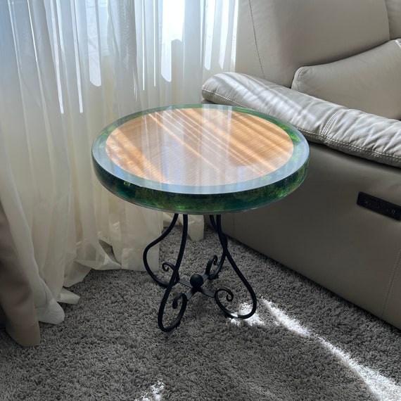A round live-edge side table with real moss embedded in the epoxy river — nature literally grows inside your nightstand, and 31 favorites prove people are obsessed.