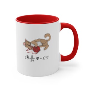 Peut inclure: Une tasse en céramique blanche avec un bord et une poignée rouges. La tasse présente une illustration de dessin animé d'un chat jouant avec une pelote de laine. Le texte "ih d/dt ψ = Hψ" est imprimé sous le chat.