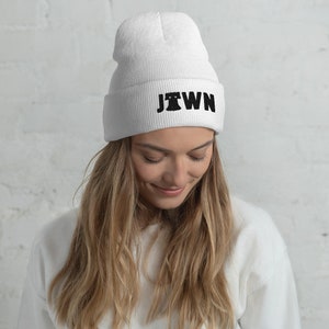 May include: White beanie with a black embroidered design that says "JTOWN" with a stylized Liberty Bell graphic.