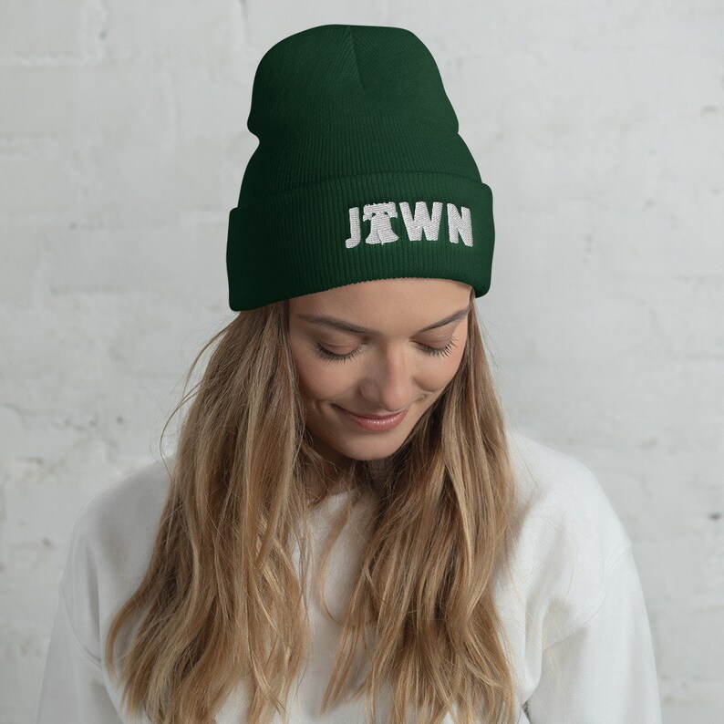 May include: A dark green beanie with a white embroidered design that says "JTOWN".