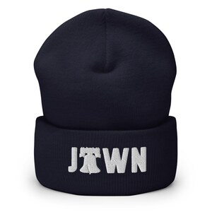 May include: Navy blue beanie with a white embroidered Liberty Bell and the word "JTOWN" on the cuff.