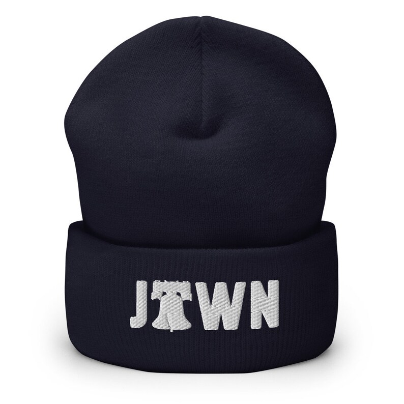 May include: Navy blue beanie with a white embroidered Liberty Bell and the word "JTOWN" on the cuff.