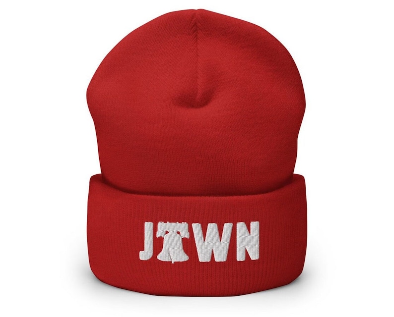 May include: Red knit beanie with a white embroidered Liberty Bell and the word "Jawn" on the cuff.
