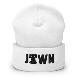 May include: White knit beanie with a black embroidered Liberty Bell and the word "JTOWN" on the cuff.