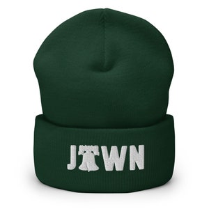 May include: A dark green beanie with a white embroidered Liberty Bell and the word "JTOWN" on the cuff.