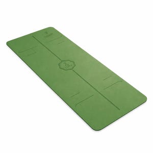 May include: Green yoga mat with a centered line and etched design. The mat has a rectangular shape with rounded corners. The top of the mat has the word "FOGGERS" and a star etched into the surface.