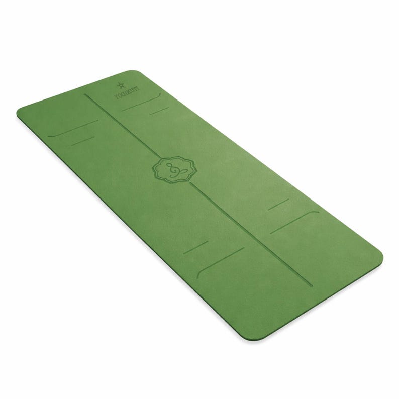 May include: Green yoga mat with a centered line and etched design. The mat has a rectangular shape with rounded corners. The top of the mat has the word "FOGGERS" and a star etched into the surface.