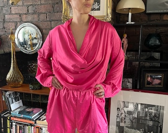 Vintage 1980s shocking pink playsuit Long sleeve short play suit with exaggerated cowl neckline front and back.Small to Medium vgc
