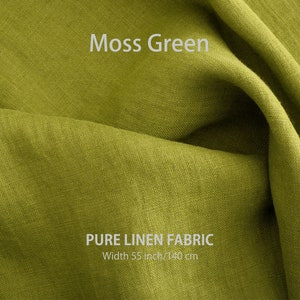 May include: A close-up of a soft, moss green linen fabric. The fabric is folded and has a natural, textured look. The text "PURE LINEN FABRIC" and "Width 55 inch/140 cm" is printed on the fabric.