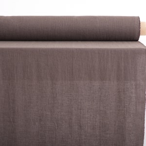 May include: A roll of brown linen fabric. The fabric is woven with a subtle texture and has a natural, earthy tone.