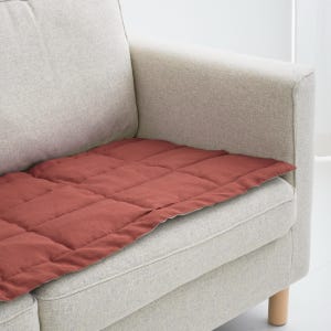 Modern couch with beige linen slipcover only on sitting area, designed for daily use by pets and kids, adds texture and comfort to the space.