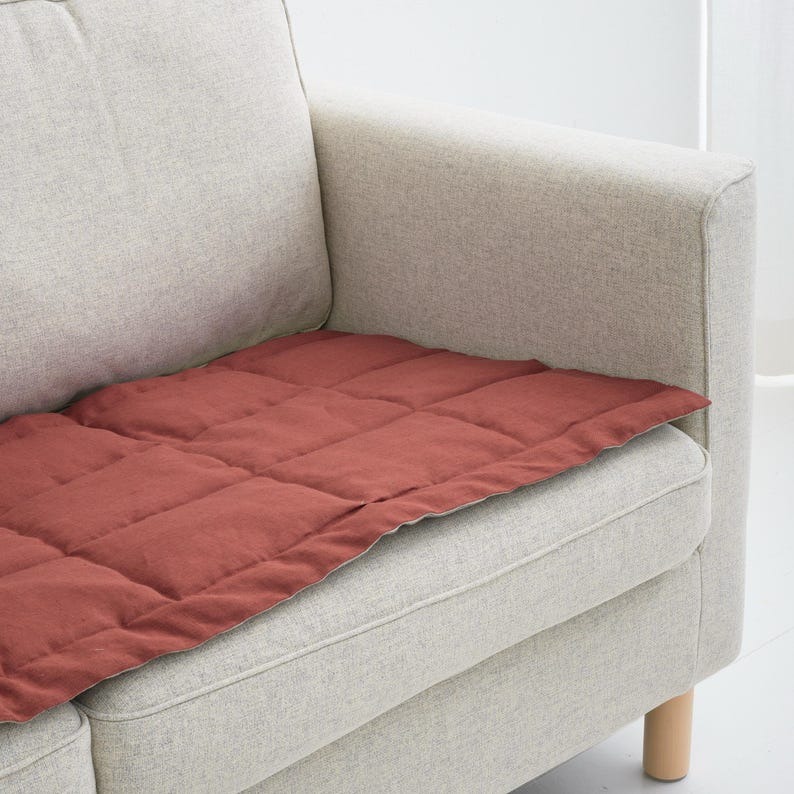 Modern couch with beige linen slipcover only on sitting area, designed for daily use by pets and kids, adds texture and comfort to the space.