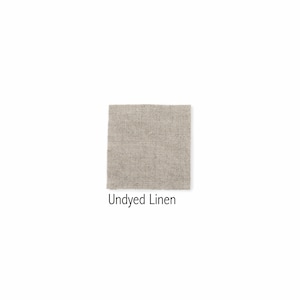 May include: A close-up of undyed linen fabric. The fabric has a natural, off-white color and a slightly textured surface.
