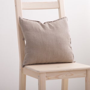 Natural linen pillow case on a chair.
