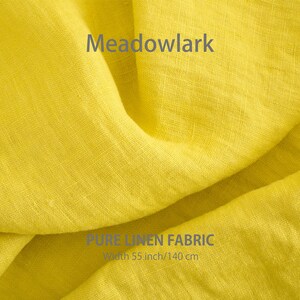 May include: Close-up of a bright yellow linen fabric with the text "Meadowlark" and "PURE LINEN FABRIC" in gray. The fabric is 55 inches wide or 140 centimeters.