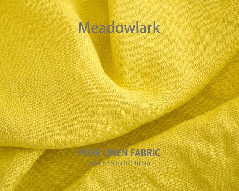 May include: Close-up of a bright yellow linen fabric with the text "Meadowlark" and "PURE LINEN FABRIC" in gray. The fabric is 55 inches wide or 140 centimeters.