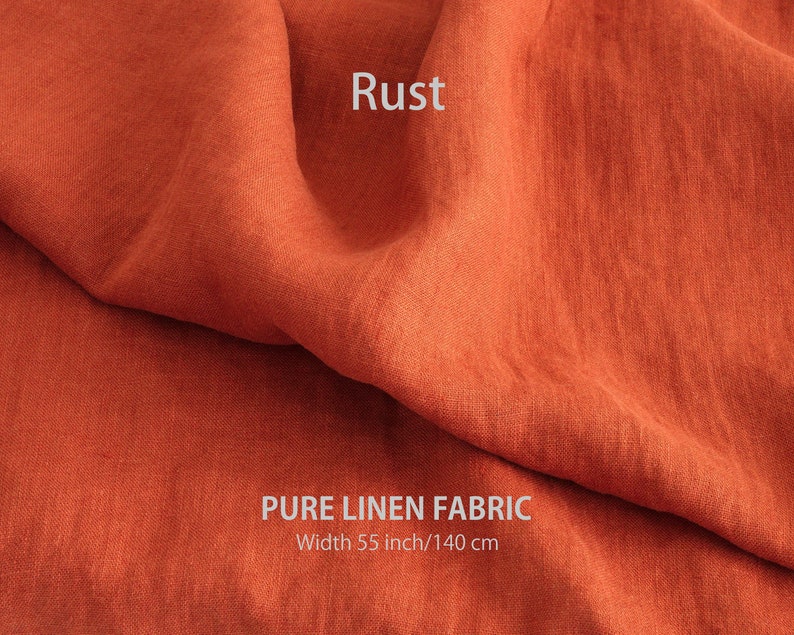 May include: Rust colored pure linen fabric. The fabric is folded and has a textured surface.  Width: 55 inch/140 cm.