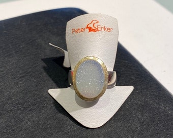 Radiant elegance: Sterling silver ring with light blue Drusy and gold-plated edge