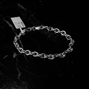 May include: A silver chain bracelet with a lobster clasp.