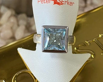 Sterling silver ring with topaz (blue) in princess cut by Peter Erker item R75TO