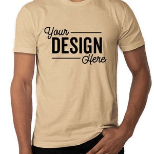 May include: A beige short-sleeved t-shirt with the text "Your Design Here" printed on the front.