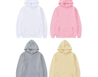 May include: A collection of four long-sleeve hooded sweatshirts, each featuring a front kangaroo pocket, ribbed cuffs, and a ribbed hem. The hoodies are presented in solid colors: white, light pink, heather gray, and pale yellow.