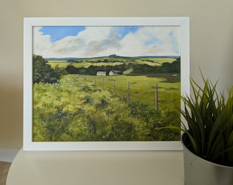 May include: A framed oil painting depicting a rural landscape with a green field, a fence, and a small building in the distance. The sky is blue with white clouds.