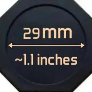 May include: A black octagonal-shaped object with a white circle in the center. The circle has the text "29 mm" and "~1.1 inches" printed in white.