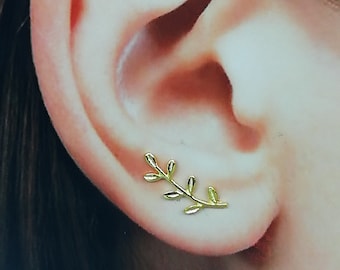 May include: Gold leaf ear cuff with a delicate branch design. The cuff is worn on the upper part of the ear.
