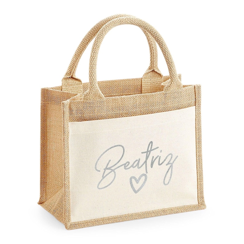 A beige tote bag with a printed name on it.