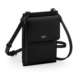 A black crossbody bag with a zipper closure and a front pocket.