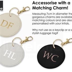 three round keychains with personalized initials on them, each with a unique color and charm.